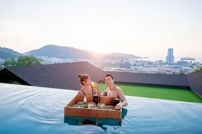 a man and woman in a wooden boat in the water at The Senses Resort & Pool Villas, PHUKET in Patong Beach