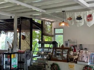 a shop with a counter and windows in a room at Nua Tone Resort Bang Tao & Cafe in Bang Tao Beach