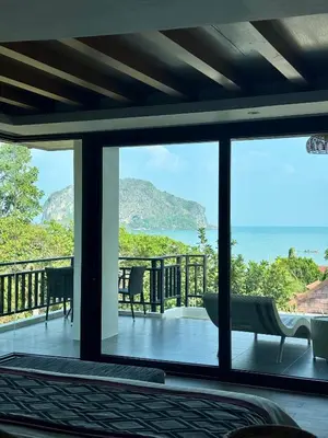 a bedroom with a view of the ocean at Baan Taranya Koh Yao Yai Resort in Ko Yao Yai