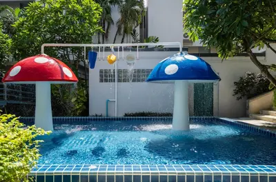 two mushroom shaped fountains in a swimming pool at Phuket Island View Resort - SHA Extra Plus in Karon Beach