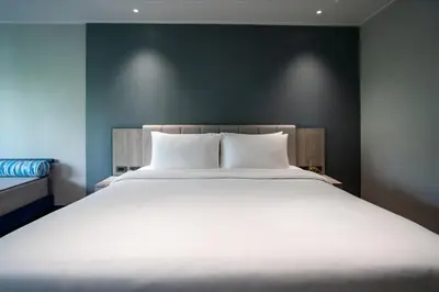 a bedroom with a large bed with white sheets at Phuket Island View Resort - SHA Extra Plus in Karon Beach
