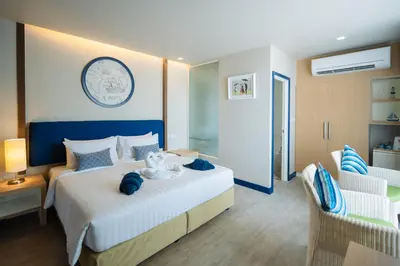 a hotel room with a bed with a stuffed animal on it at Phuket Boat Quay Hotel Panwa Beach in Panwa Beach