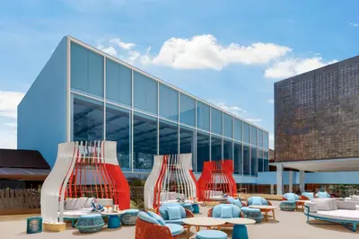 a building with chairs and tables in front of a building at Courtyard by Marriott Phuket, Patong Beach Resort in Patong Beach