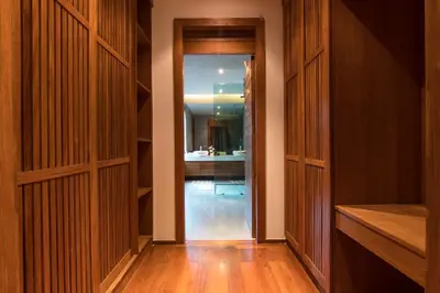 a hallway with wood paneled cabinets and a bathroom at Luxurious SeaView 4br Private Pool Villa by Intira Villas in Rawai Beach