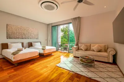a bedroom with a bed and a couch at Luxurious SeaView 4br Private Pool Villa by Intira Villas in Rawai Beach