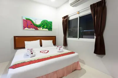 a bedroom with a large white bed with two hello kitty at Freedom Hotel in Patong Beach