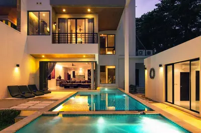 a house with a swimming pool in front of it at Amazing 5br, Seaview private PoolVilla by Intira Villas in Rawai Beach