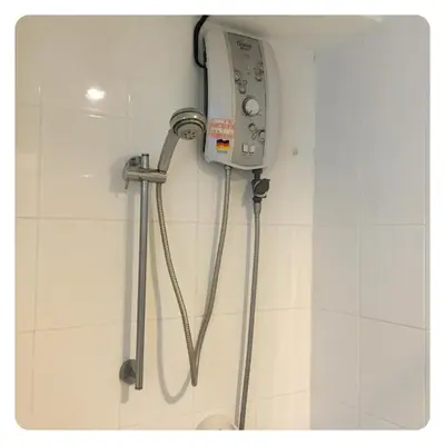 a shower in a bathroom with a phone on the wall at Apartment in Ranghill Residence Phuket by month in Phuket Town