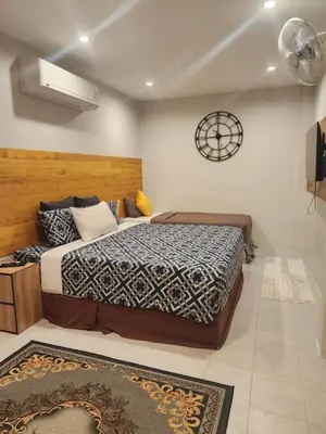 a bedroom with a bed and a clock on the wall at Momento Bangtao Beach in Bang Tao Beach