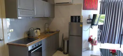 a kitchen with a refrigerator and a sink at Villa Versace Residence in Patong Beach