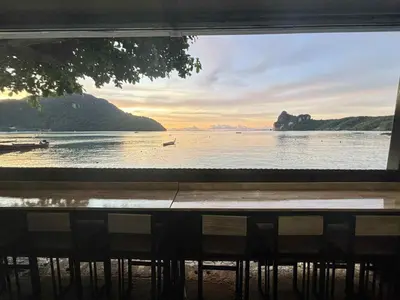 a view of the ocean from a window of a beach at The One Hostel Phi Phi Island in Phi Phi Don