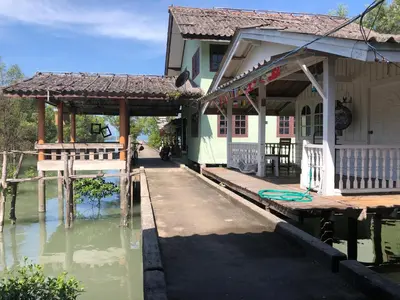 a house on a dock in the water at Fisherman Guesthouse in Ko Yao Noi