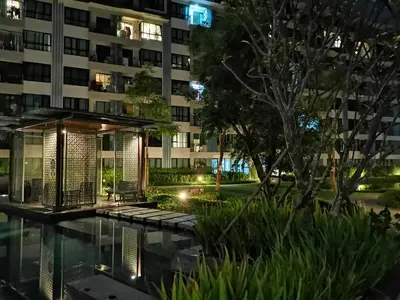 a building with a swimming pool at night at 5 Floor - Centrio Condominium in Phuket Town - 30 mins to beaches in Phuket Town