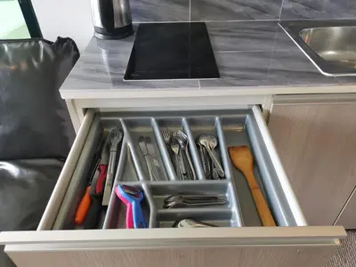a drawer in a kitchen with a tablet on top at 5 Floor - Centrio Condominium in Phuket Town - 30 mins to beaches in Phuket Town