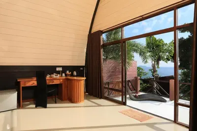 an office with a desk and large windows at The Cove Phi Phi in Phi Phi Don