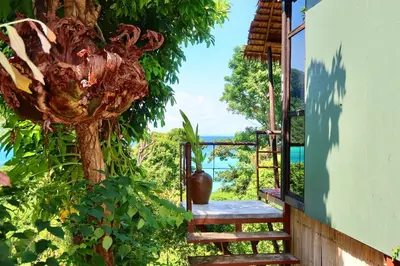 a set of stairs leading up to a house with a tree at Phi Phi Sea Sky Resort in Phi Phi Don