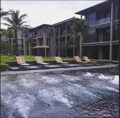 a group of chairs sitting next to a body of water at Baan mai khao apartment in Mai Khao Beach