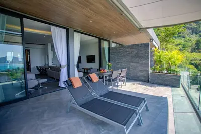 a patio with a chair and a table on a house at Ocean Rock Kalim in Patong Beach