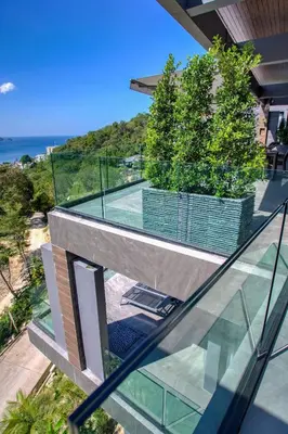 an image of a glass house with a tennis court at Ocean Rock Kalim in Patong Beach