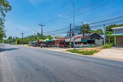 an empty street in a small town with buildings at RAT VILLA in Ban Pa Khlok