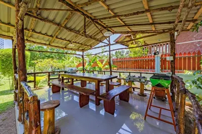 a picnic table in a pavilion with a grill at RAT VILLA in Ban Pa Khlok