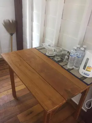 a wooden table with bottles of water on it at The Best Bungalow in Ban Bang Chak