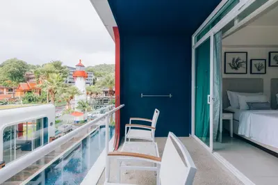 a room with a balcony with a bed and a bed and a view at Sugar Marina Hotel - NAUTICAL - Kata Beach in Kata Beach