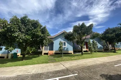 a blue house on the side of a street at Be Leaf Resort SHA in Thalang