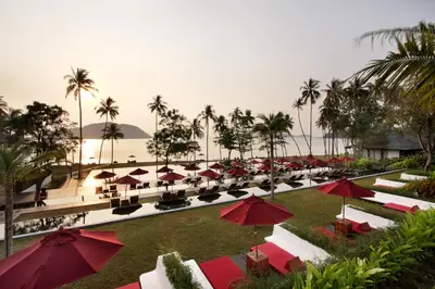 a row of tables and umbrellas at a resort at The Vijitt Resort Phuket - SHA Extra Plus in Rawai Beach