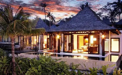 a villa with a pool in front of a house at The Vijitt Resort Phuket - SHA Extra Plus in Rawai Beach