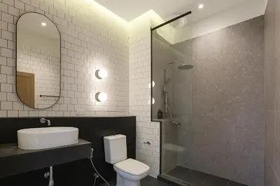 a bathroom with a toilet and a sink and a shower at Our Nomad Boutique Hostel in Phuket Town