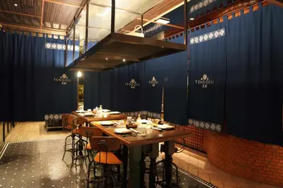 a dining room with a long table and chairs at InterContinental Phuket Resort by IHG in Kamala Beach