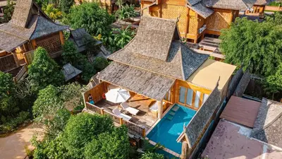 an aerial view of a house with a swimming pool at Santhiya Phuket Natai Resort & Spa in Natai Beach