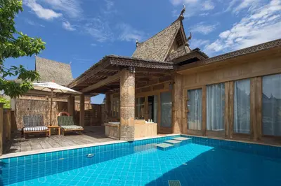a villa with a swimming pool and a house at Santhiya Phuket Natai Resort & Spa in Natai Beach
