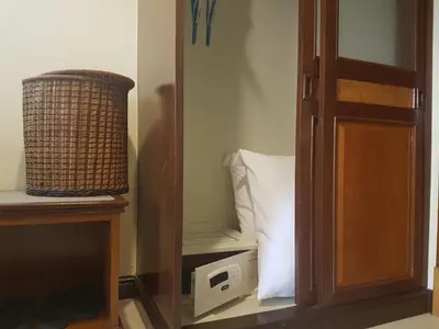 a room with a bed with a pillow and a mirror at Phi Phi Hotel in Phi Phi Don