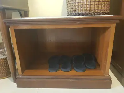 a row of shoes in a wooden shelf at Phi Phi Hotel in Phi Phi Don