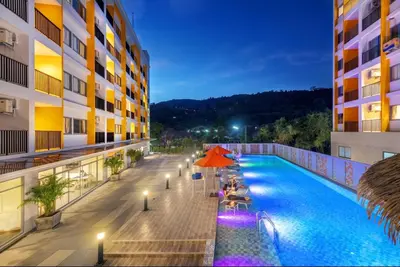a view of a hotel swimming pool at night at Beehive Boutique Hotel Phuket in Phuket Town