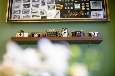 a shelf with cameras sitting on a wall at The Memory at On On Hotel in Phuket Town