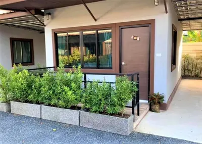 a house with plants in front of a door at Thalang resort in Thalang