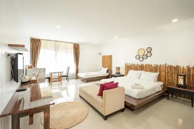 a bedroom with a bed and a living room at The Loft Panwa Resort in Panwa Beach