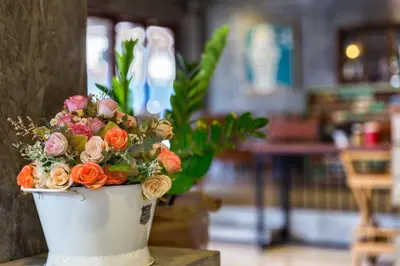 a white vase filled with flowers on a table at Memory Boutique Patong in Patong Beach