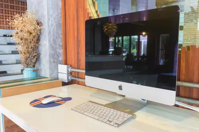 a computer monitor and a keyboard and mouse on a desk at Memory Boutique Patong in Patong Beach