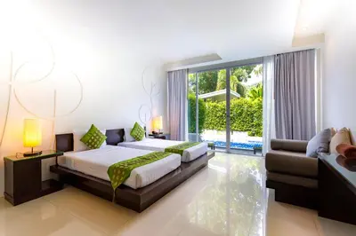 a bedroom with a bed and a couch at The Palmery Resort in Kata Beach