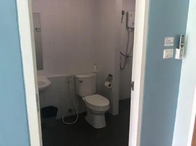a small bathroom with a toilet and a sink at Khao Oat airport in Nai Yang Beach