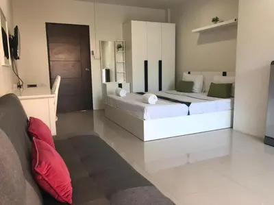 a living room with two beds and a couch at Khao Oat airport in Nai Yang Beach