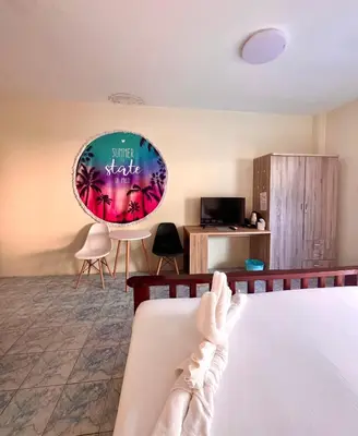 a person laying on a bed in a room at Baankasemsuk Resort \u822c\u5494 \u6df1\u5bbf in Patong Beach
