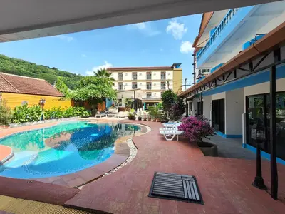 a swimming pool in front of a building at Baankasemsuk Resort \u822c\u5494 \u6df1\u5bbf in Patong Beach