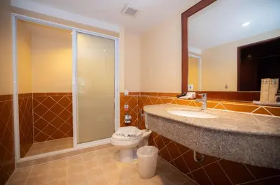 a bathroom with a toilet and a sink and a shower at Baumanburi Hotel Patong in Patong Beach