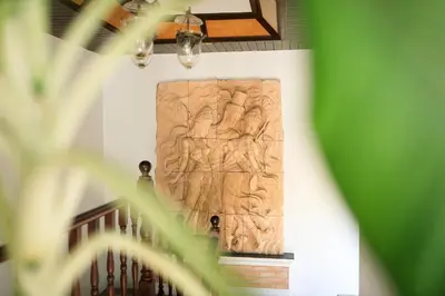 a wooden relief on the wall of a staircase at Lawootrip Villa in Patong Beach