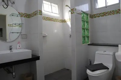 a bathroom with a toilet and a sink and a mirror at Relax private Pool Villas - 4 bedroom villas in Ao Nang Beach